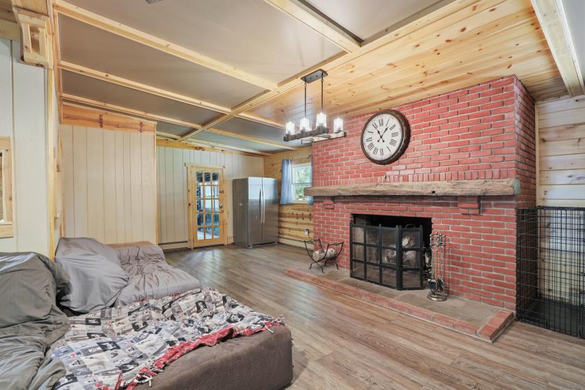 Living room with brick wood-burning fireplace at 7 Conewago Hills Rd, Mount Gretna PA